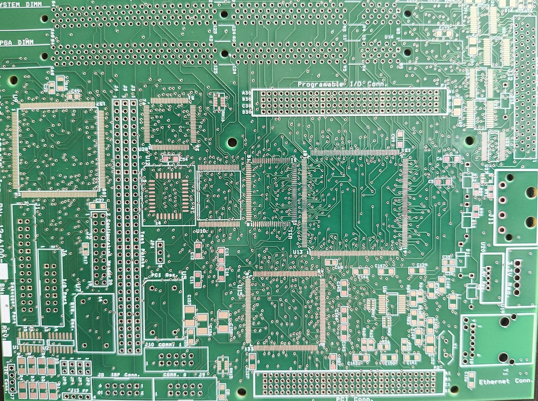 Bare green PCB motherboard showing PGA socket, DIMM slots, PCI connectors, and Ethernet port labeling